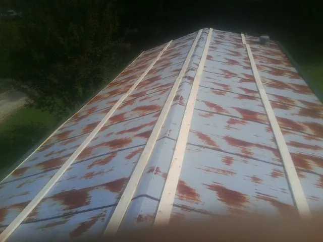 Rusted metal roof panels with new wood purlins before replacement — Storm Damage Roof Repair in Yuba City by Roofing Brothers