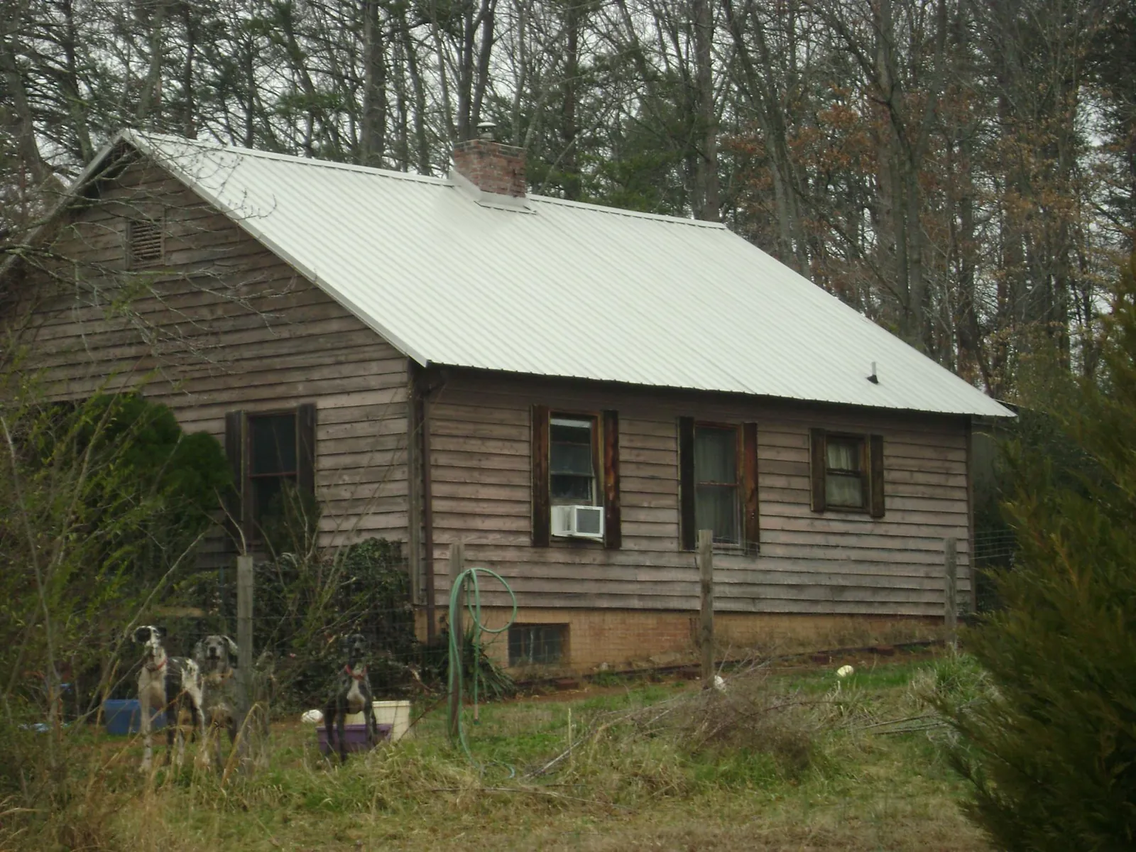 White metal roof on an old wood sided farmhouse, from a Metal Roof Installation job in Yuba City